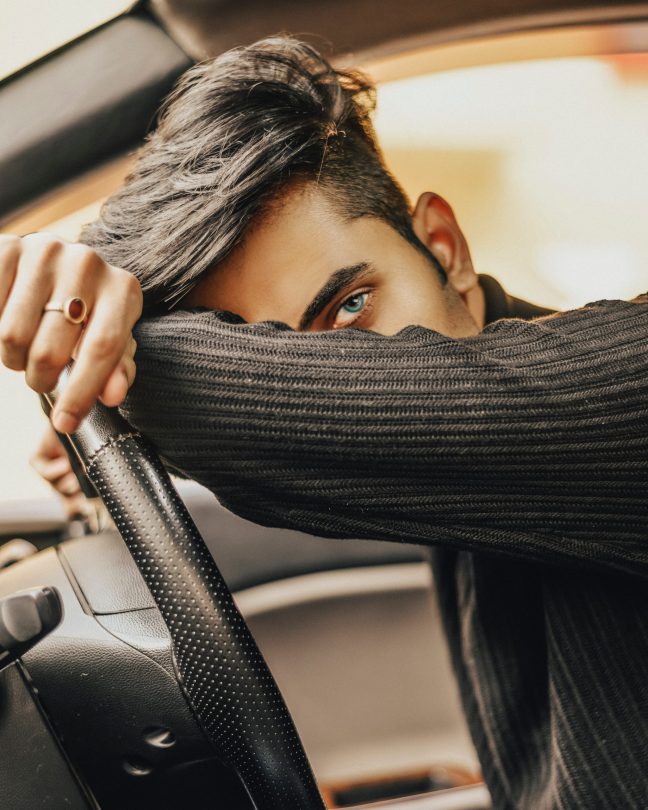 man-leaning-on-car-steering-wheel-3487217-scaled-e1581501138308