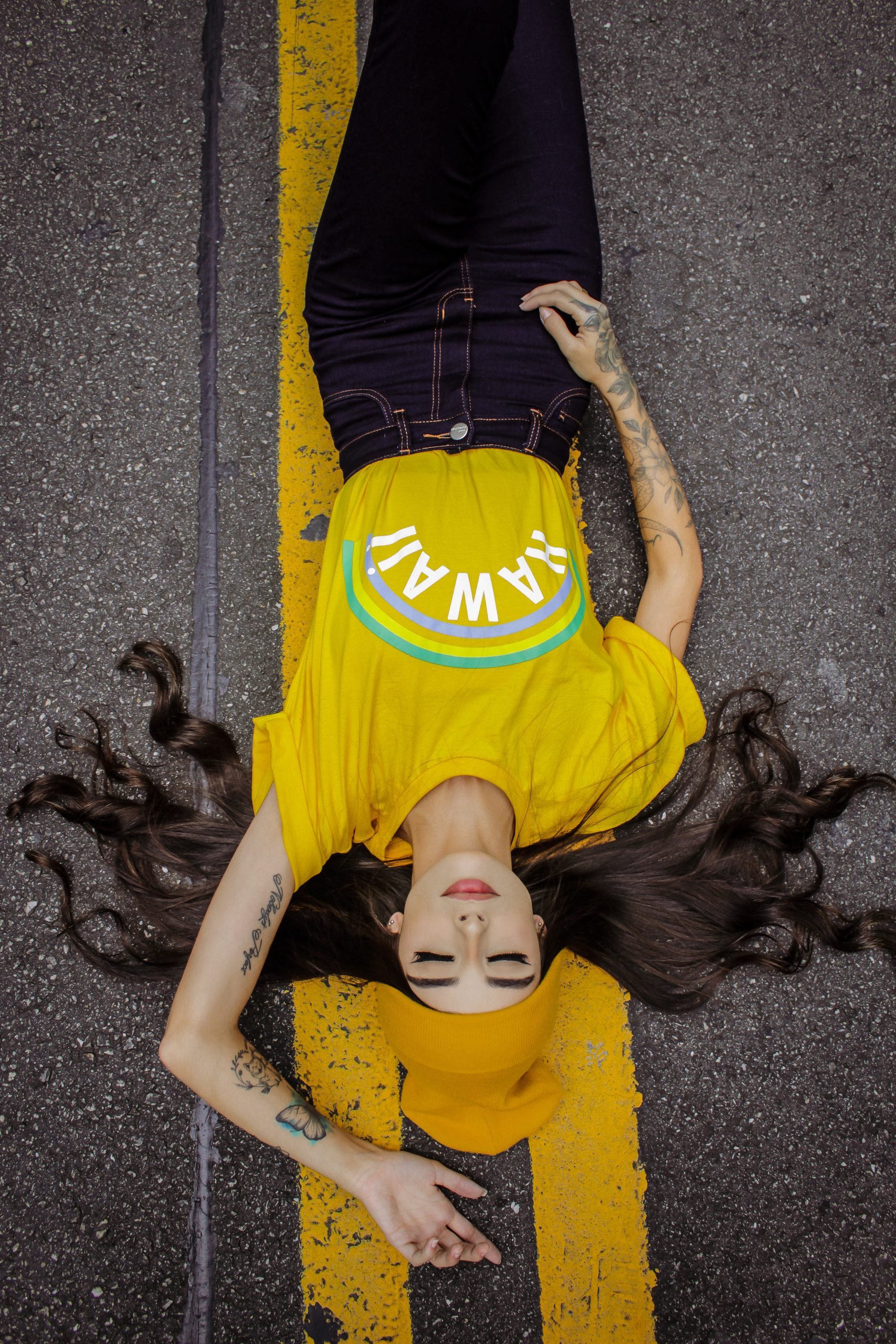 woman-in-yellow-and-black-t-shirt-lying-on-grey-concrete-3599796-scaled